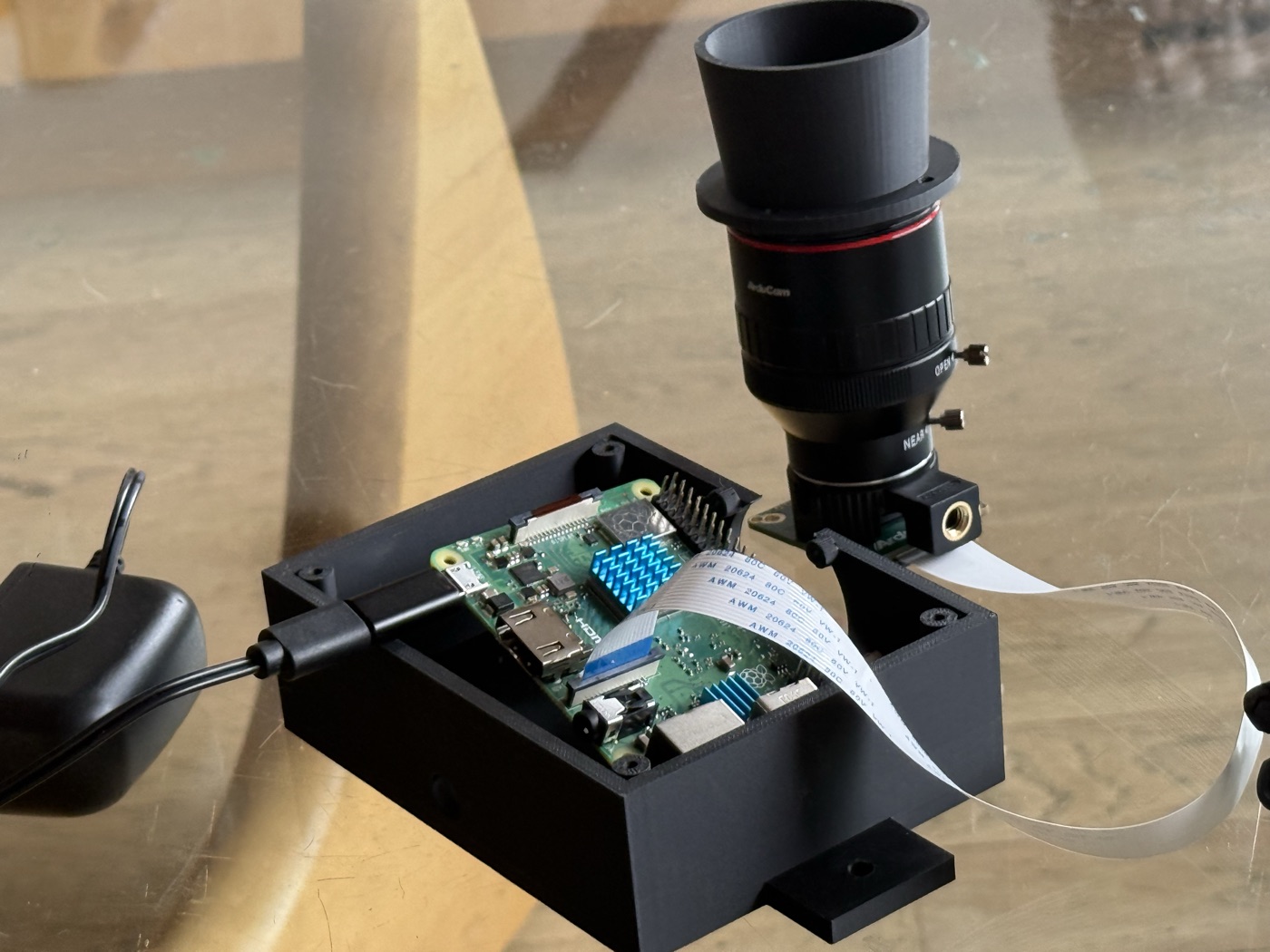 Pi and camera assembled with the v1 printed enclosure beside them